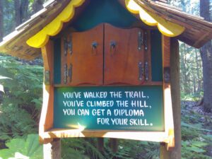 photo of a tiny box which reads "You've walked the trail, you've climbed the hill, you can get a diploma for your skill"